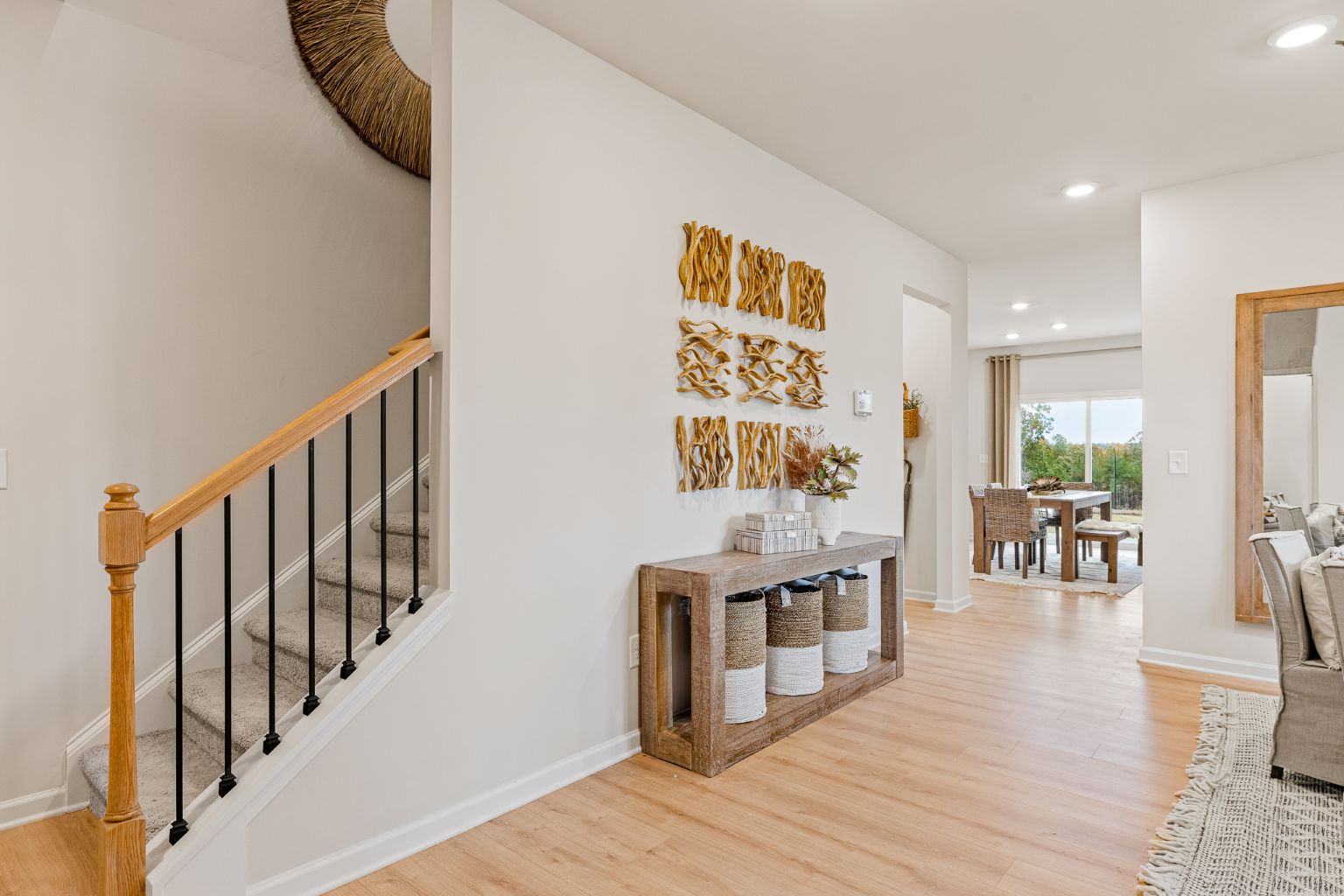 A room with a wood floor and a wood staircase.