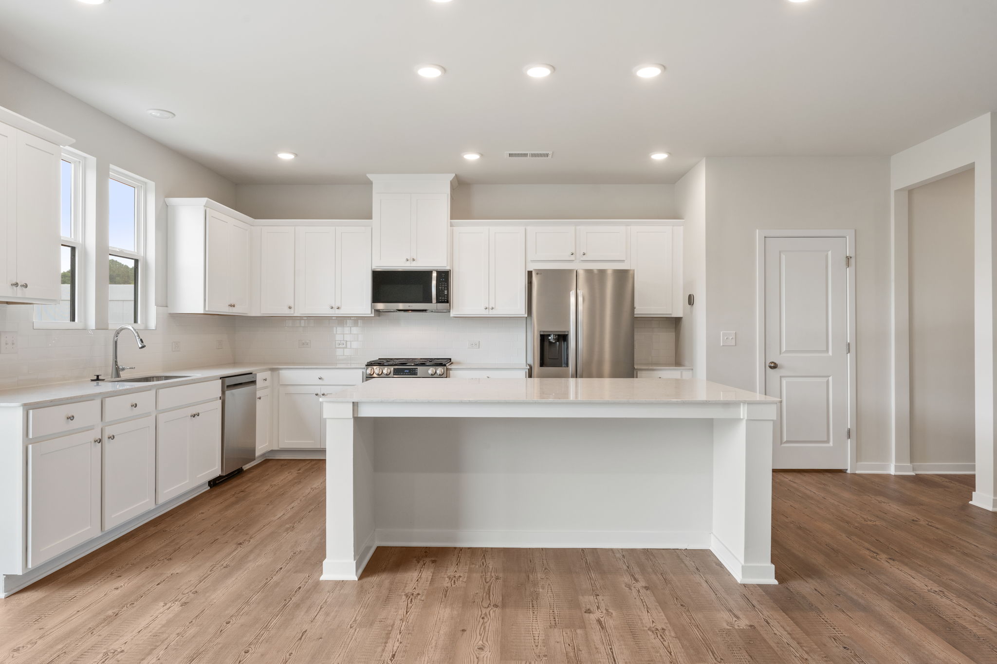 A kitchen with white cabinets.