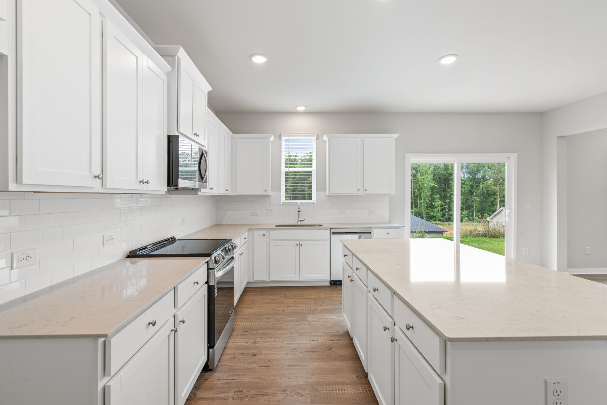 A kitchen with white cabinets.