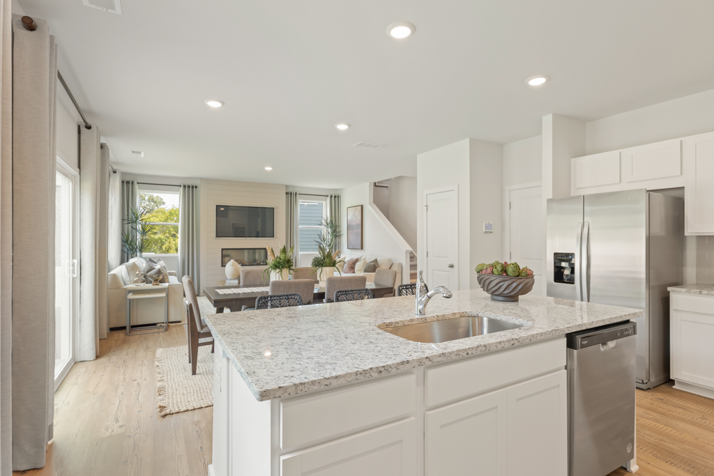 A kitchen with white cabinets.