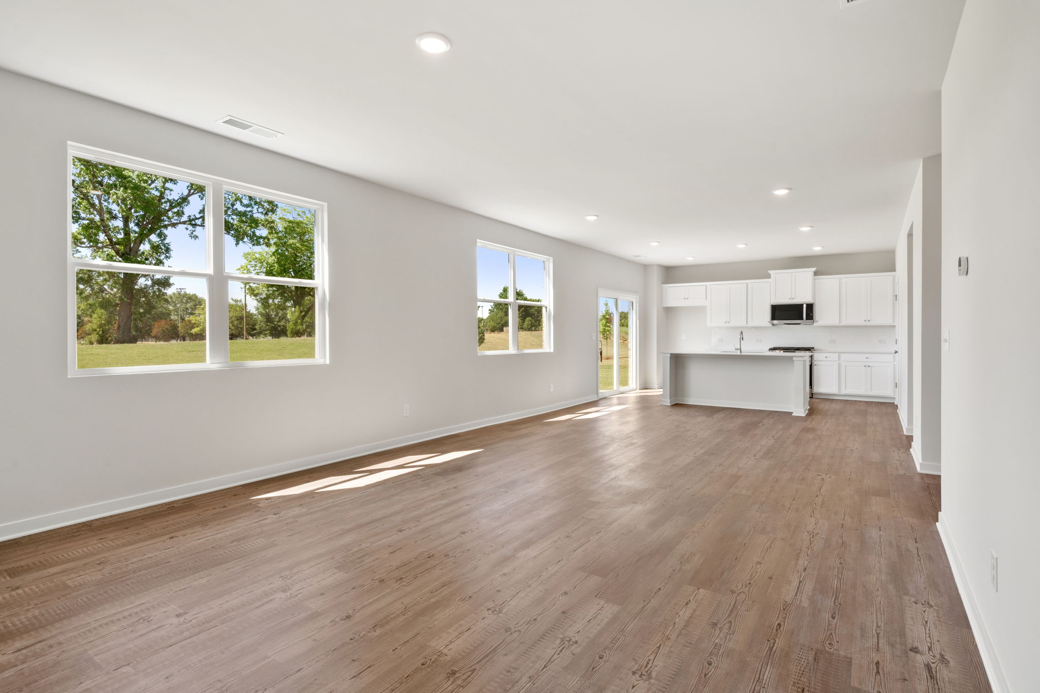 A room with a wood floor and white walls.