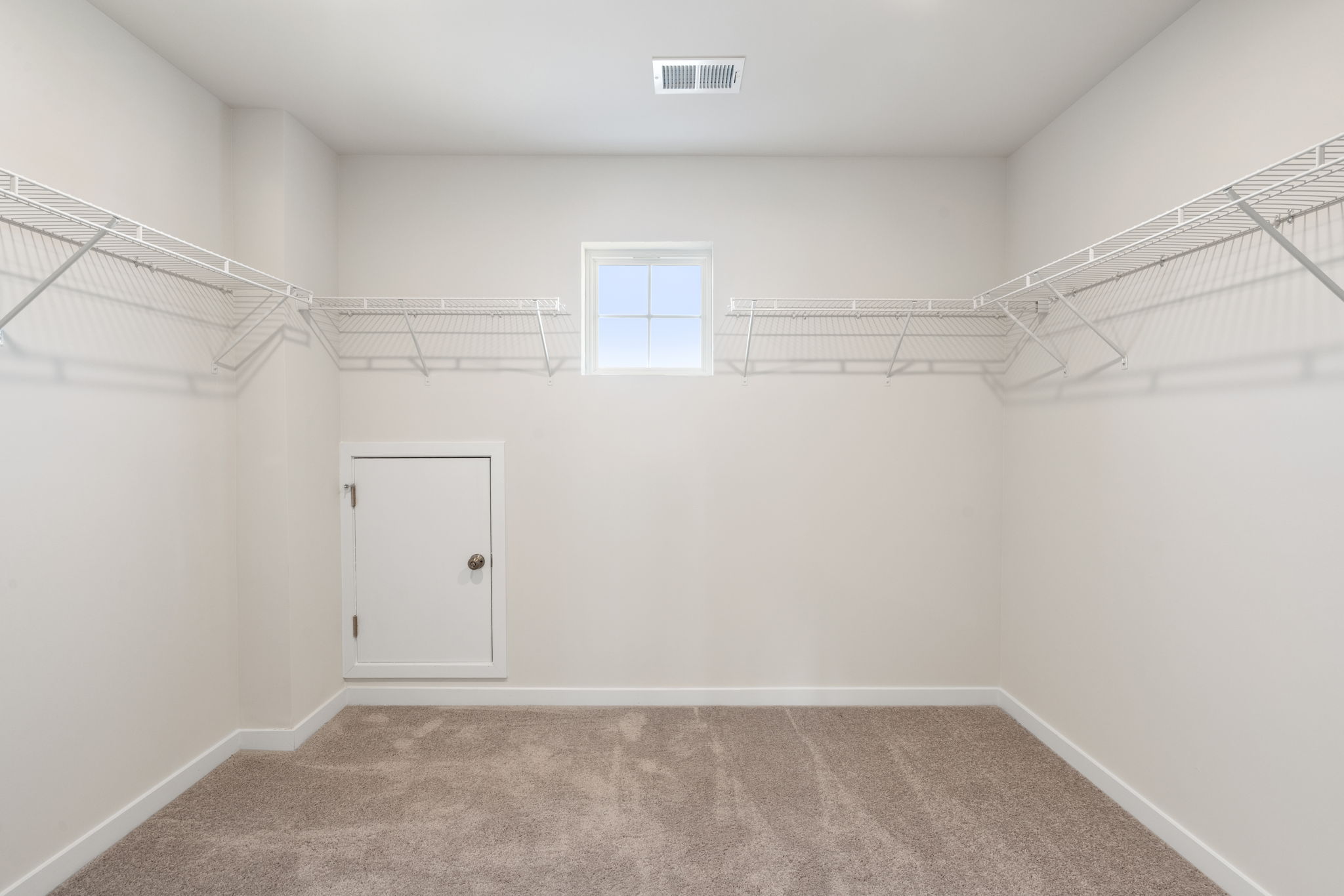 A white room with a white door.