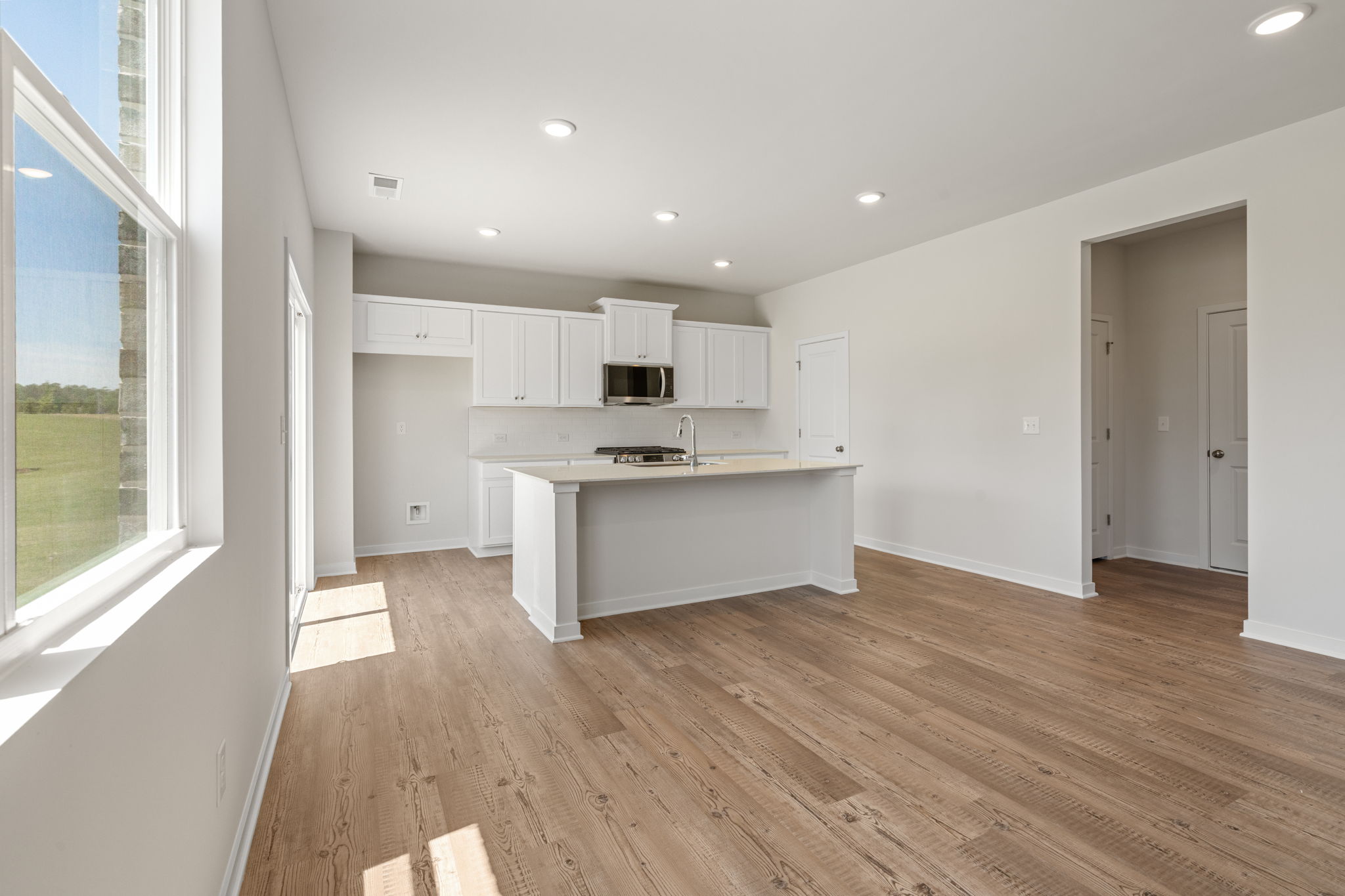 A kitchen with white cabinets.