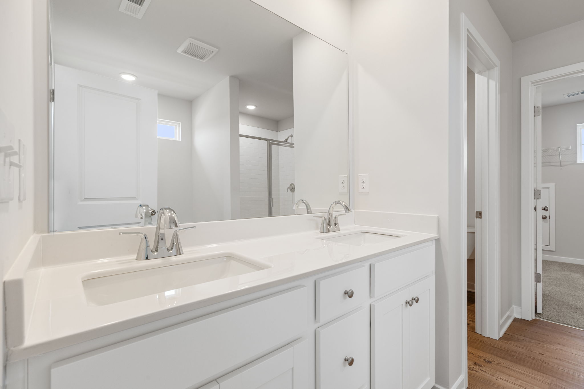 A bathroom with a large mirror.