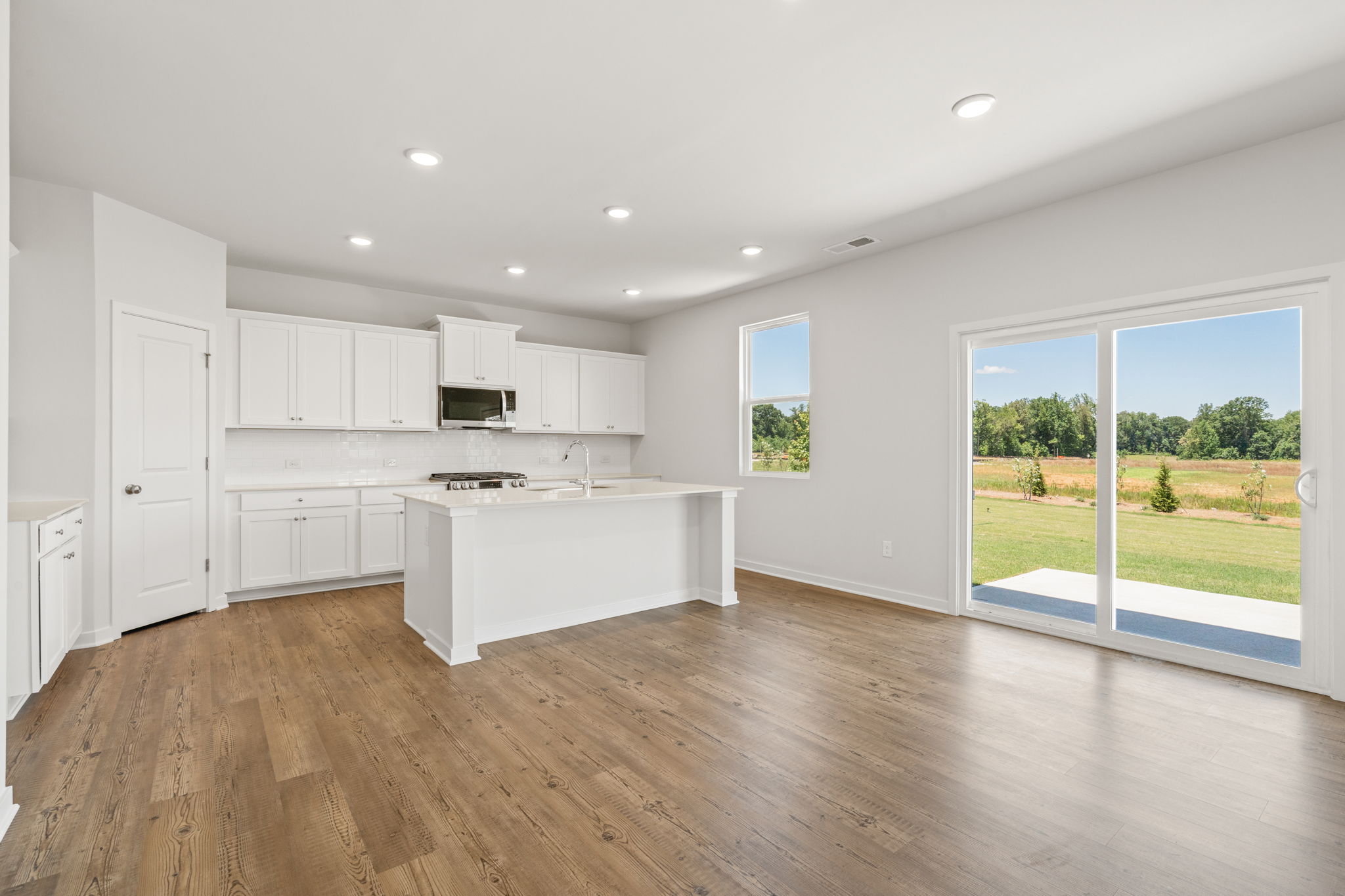 A kitchen with white cabinets.