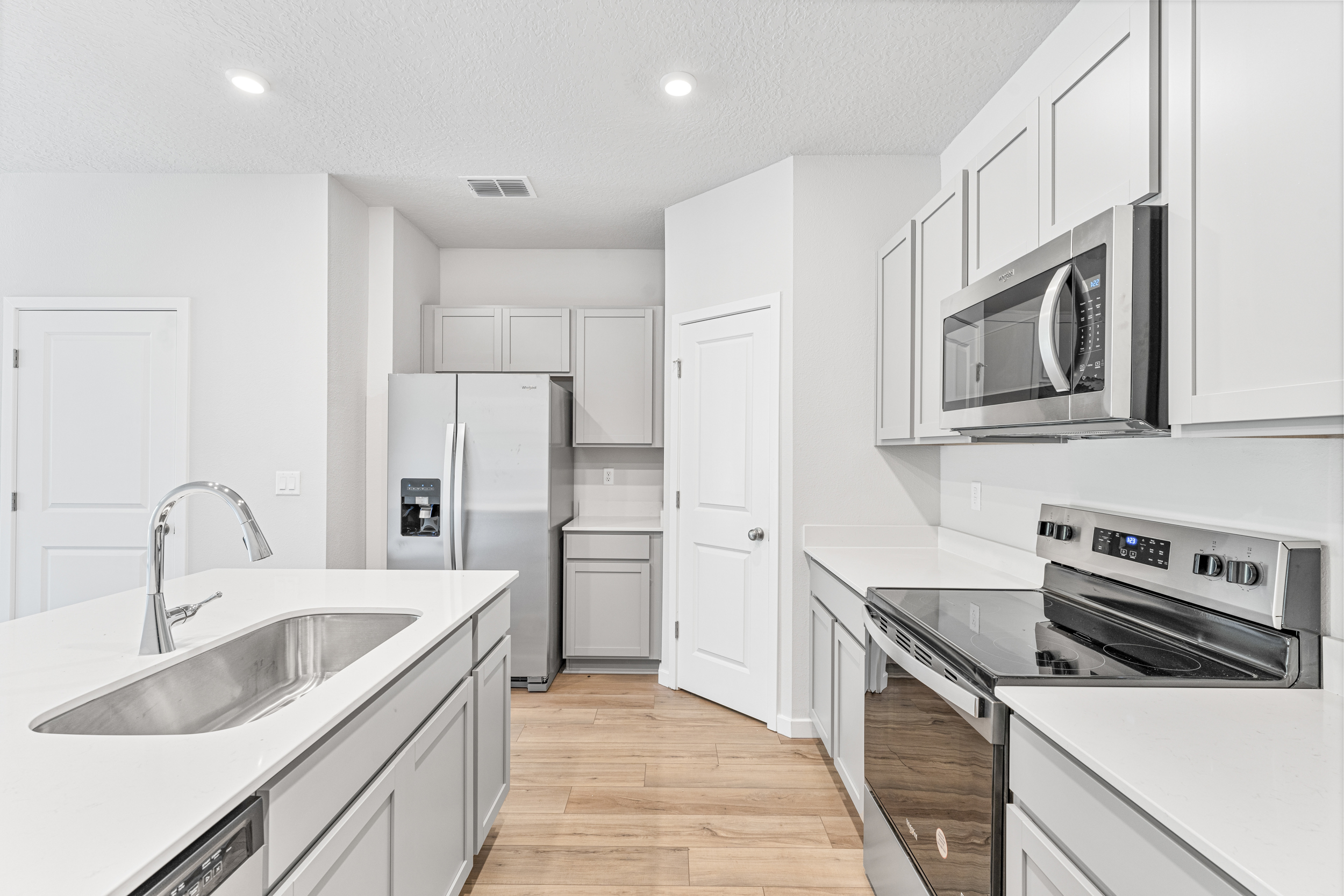 Lot 20 Townhome Kitchen with White Cabinets at The Villas at Bishop Oaks