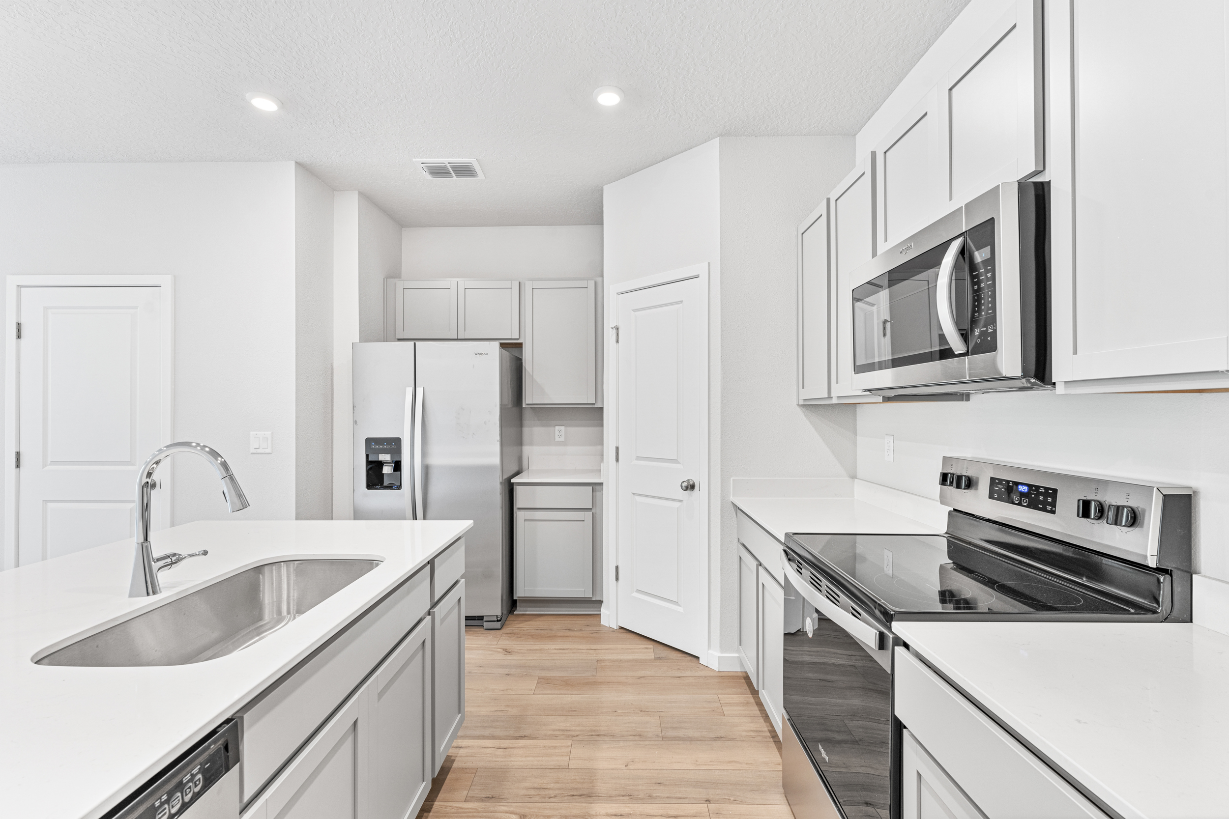 Lot 22 Townhome Kitchen with White Cabinets at The Villas at Bishop Oaks