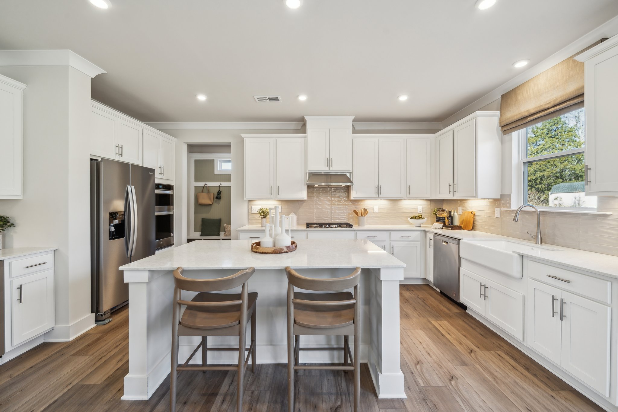 A kitchen with white cabinets.