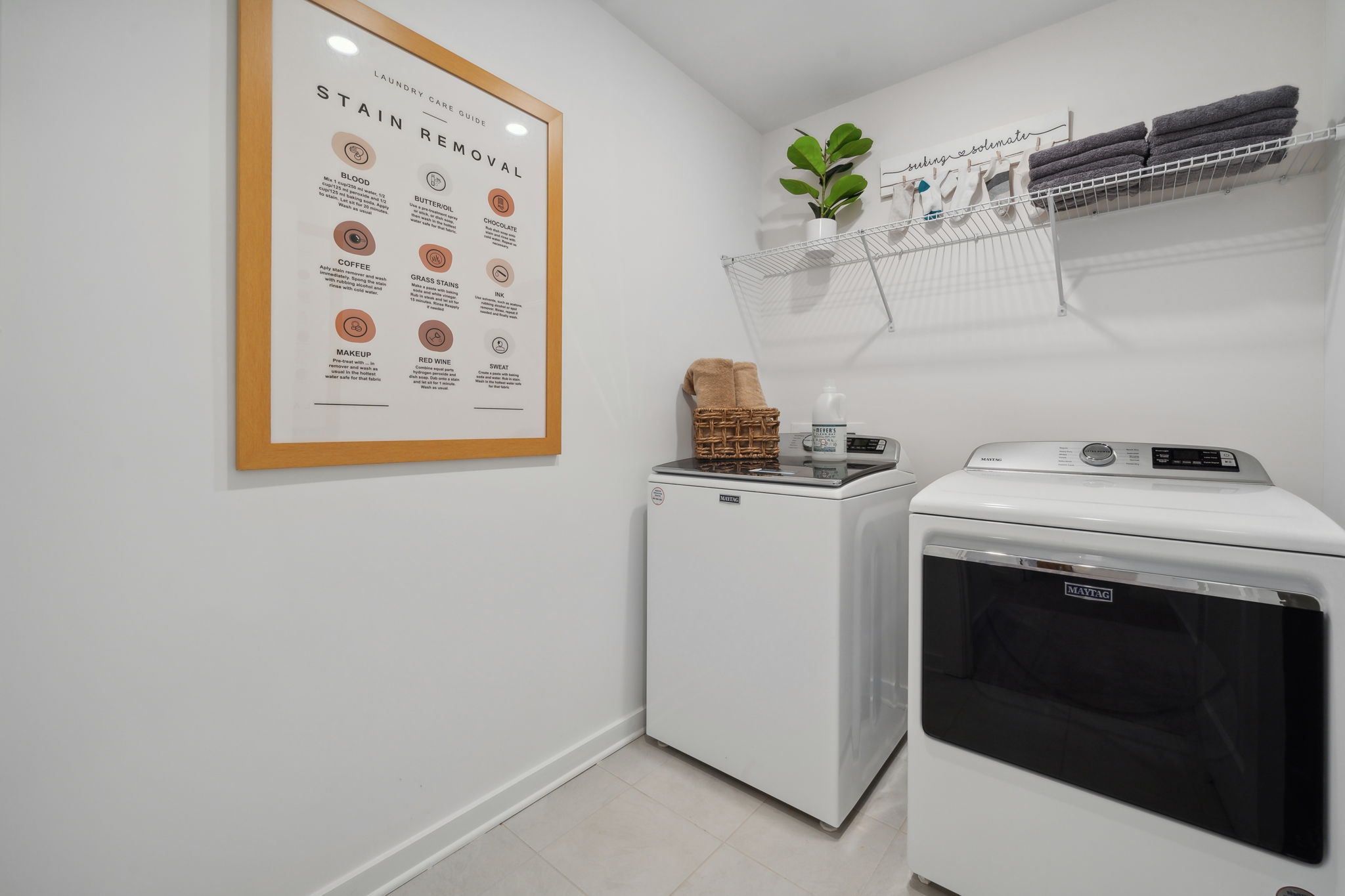 A kitchen with a white oven and a white wall.