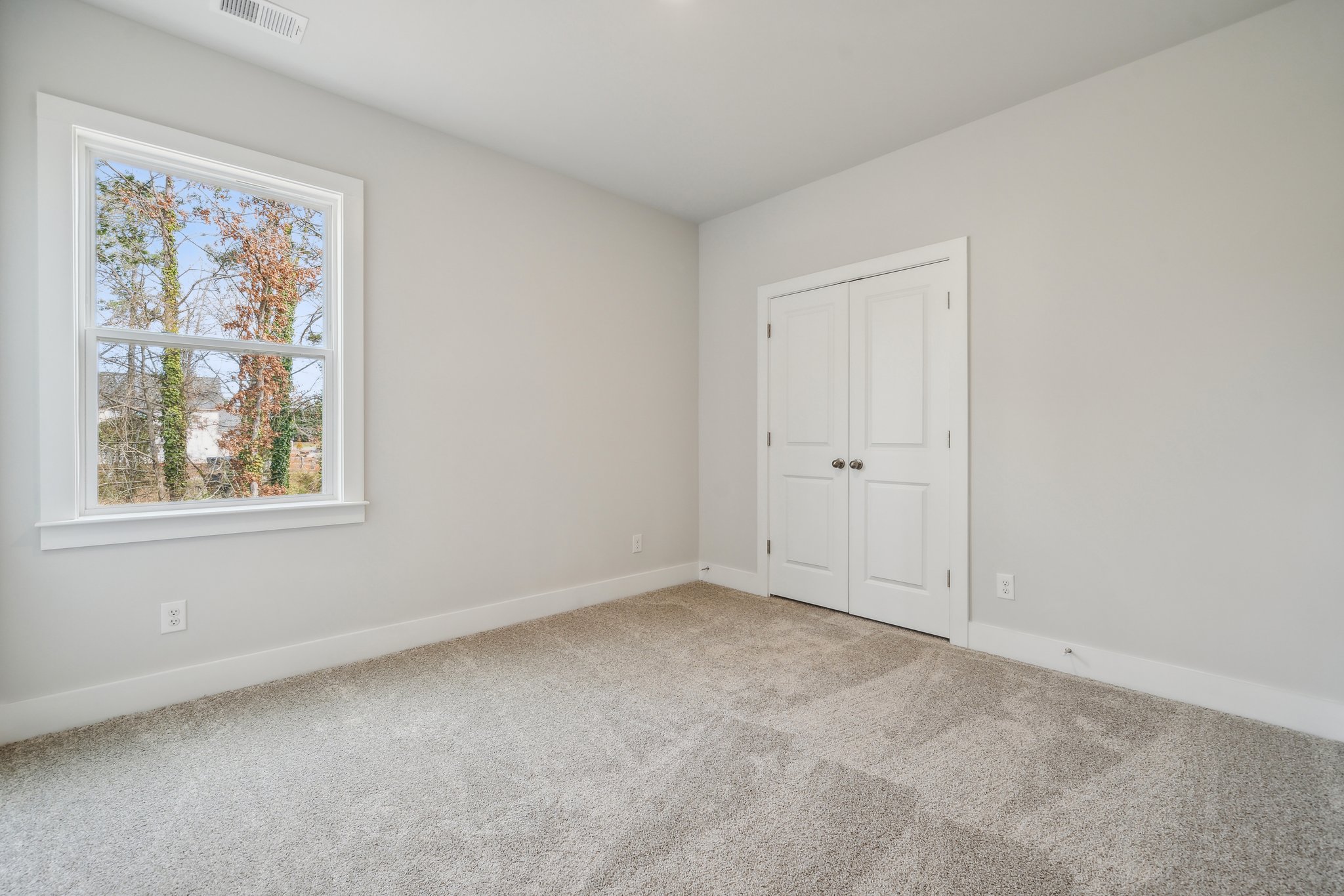 A room with a window and a door.