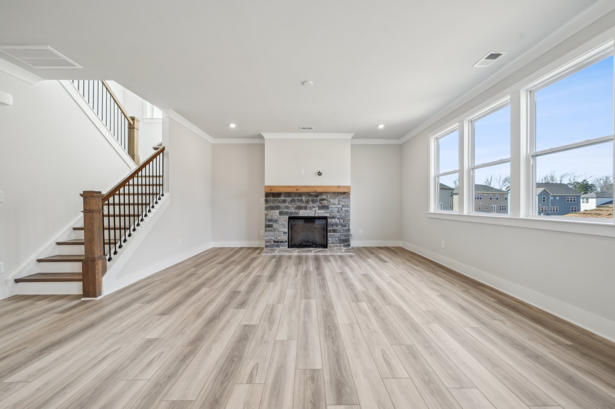 A large living room with a fireplace.