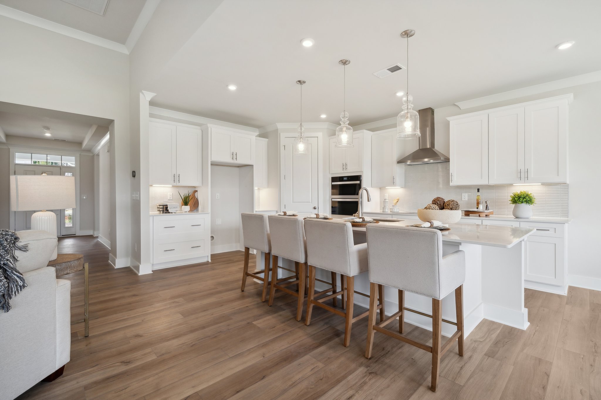 A kitchen with white cabinets.