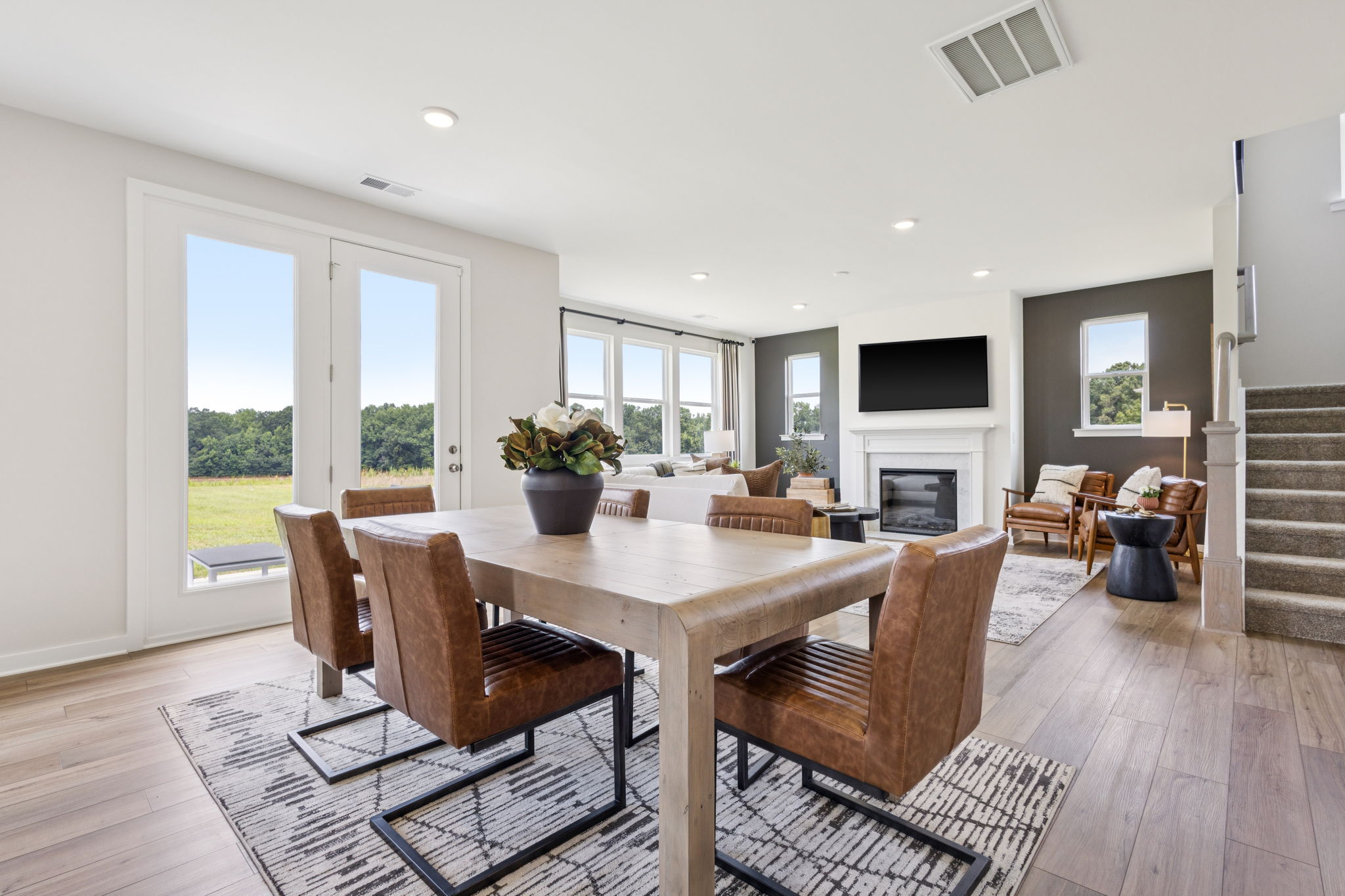 A dining room with a large table.