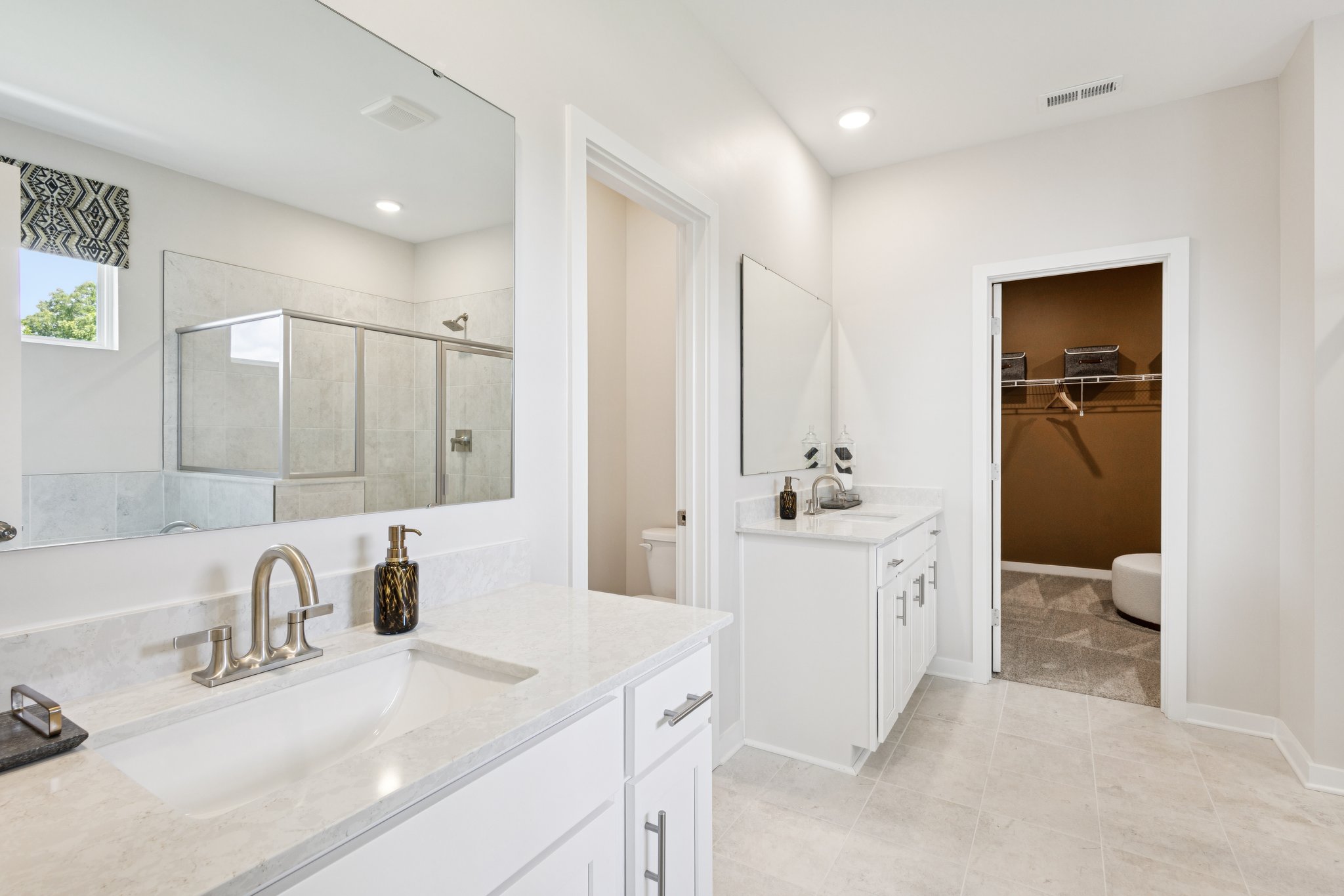A bathroom with a large mirror.