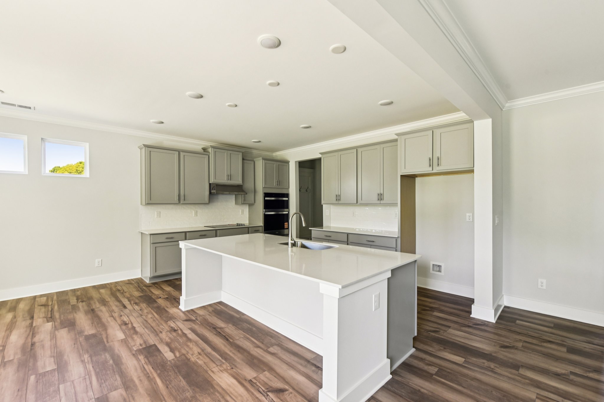 A kitchen with white cabinets.