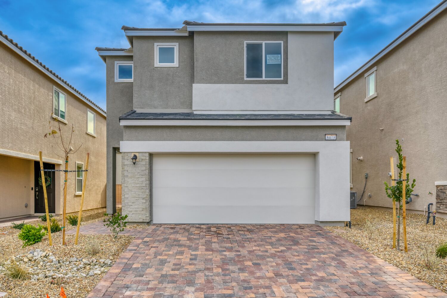 A garage in a brick driveway.