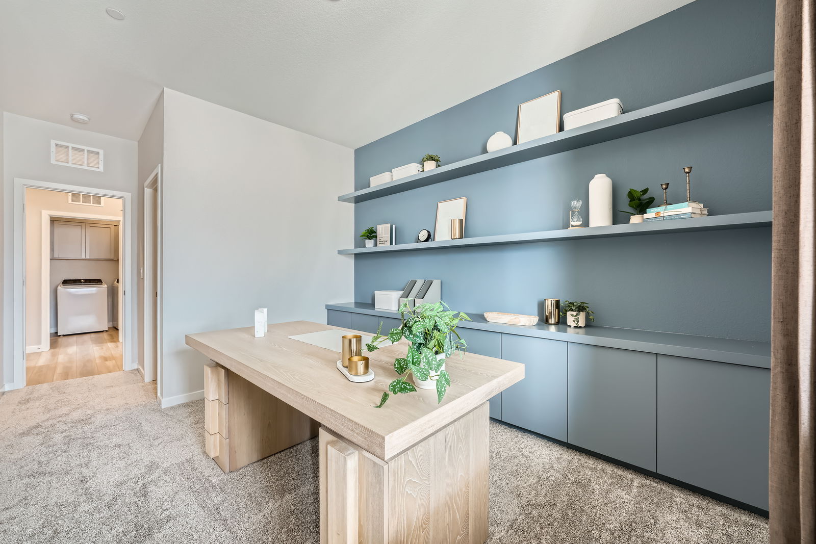 A room with a table and shelves.