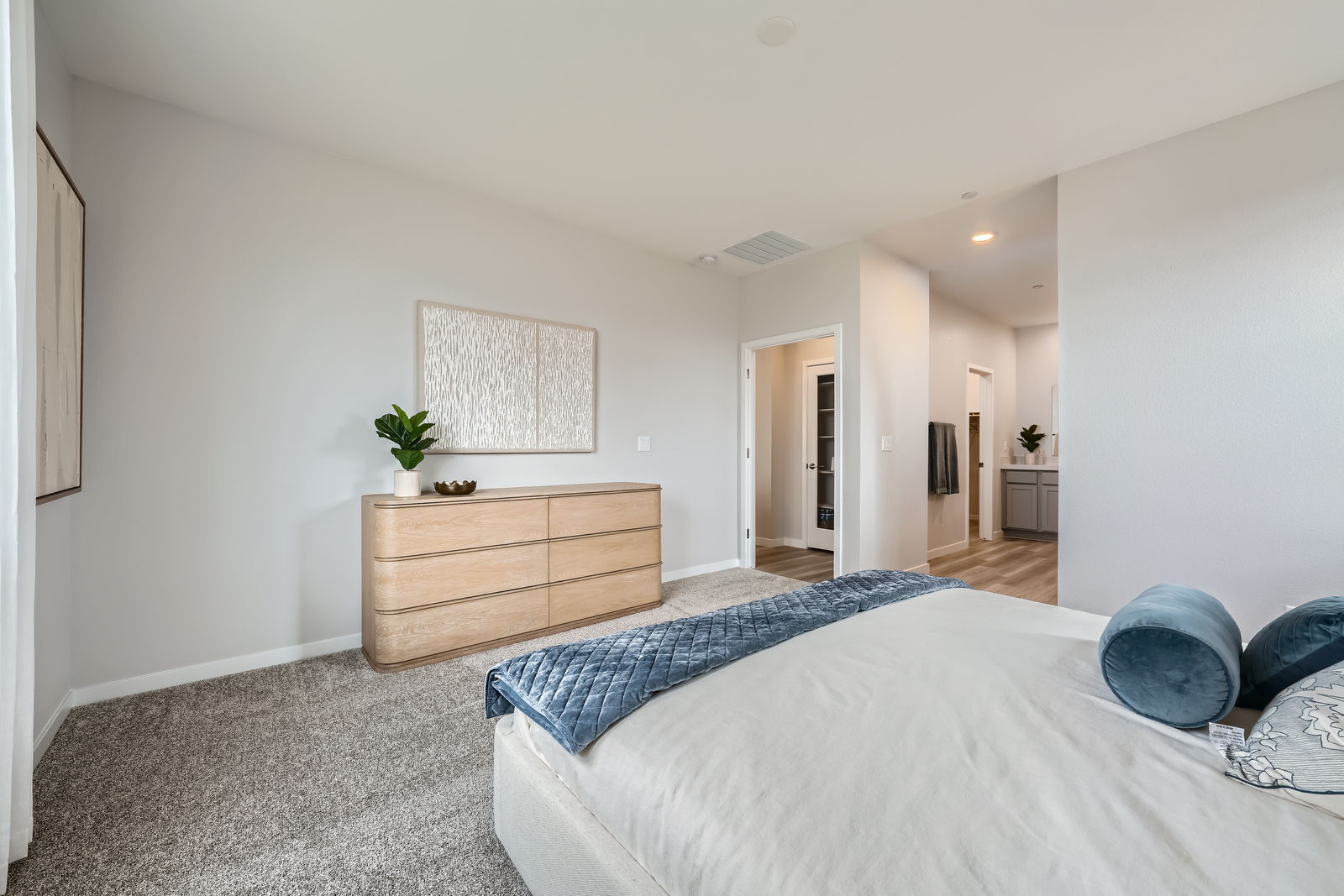 A bedroom with a bed and a dresser.