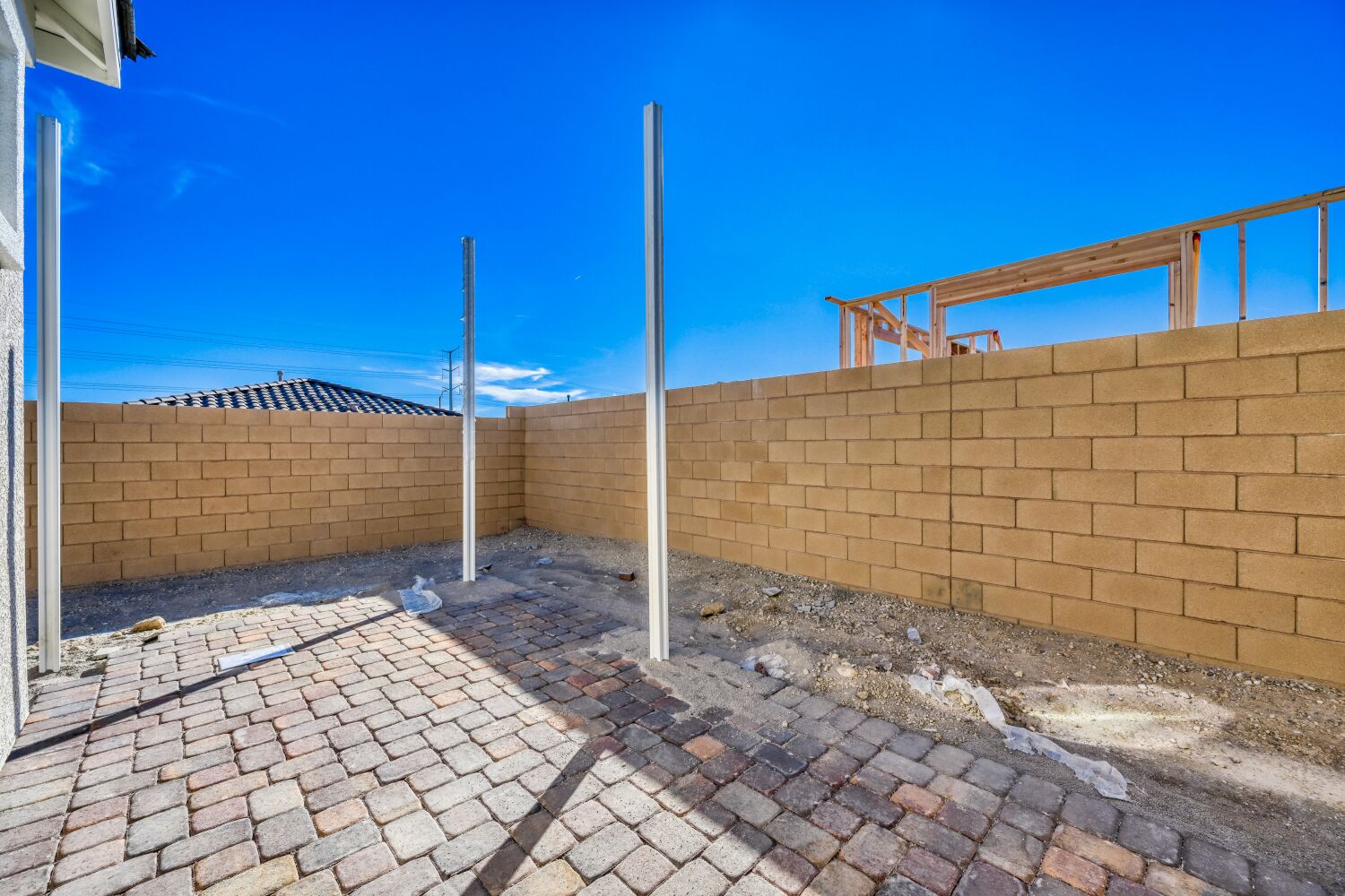 A brick wall with a brick walkway.