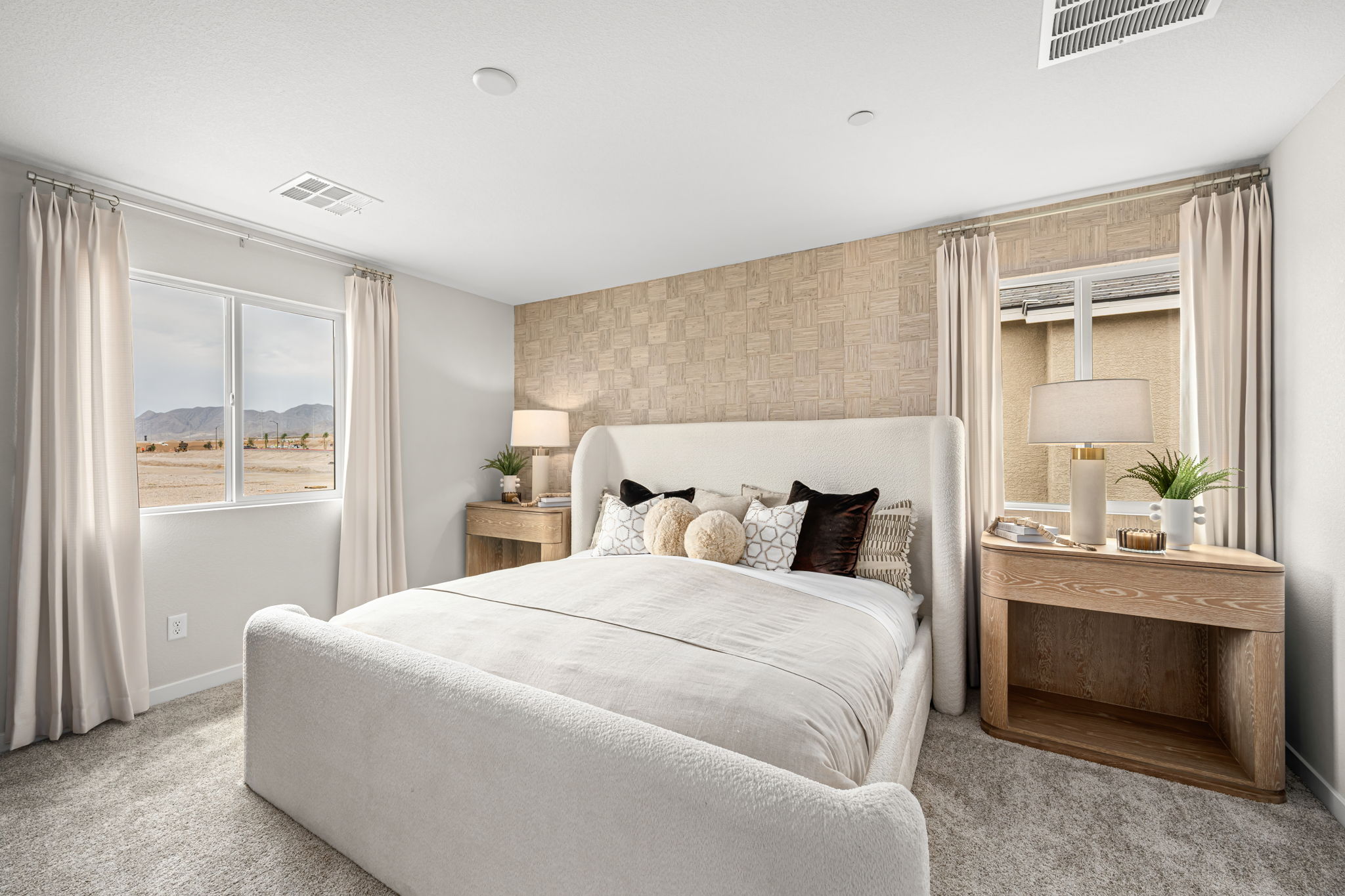 A bedroom with a bed and a table.