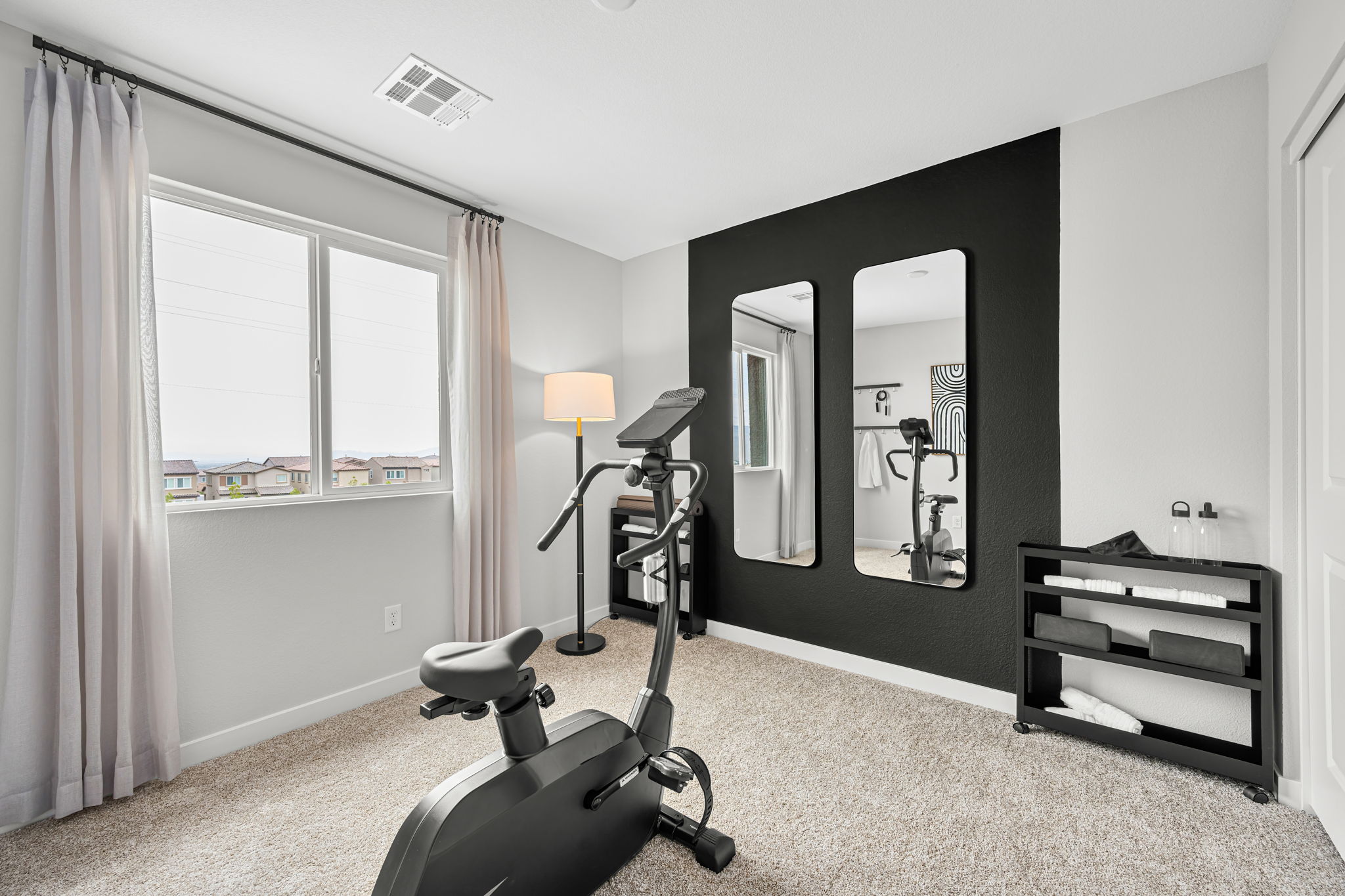 A room with a mirror and a chair.