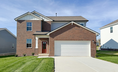 A brick house with a garage.