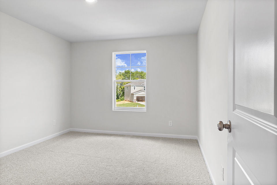 A room with a window and a door.