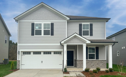 A white house with a garage.
