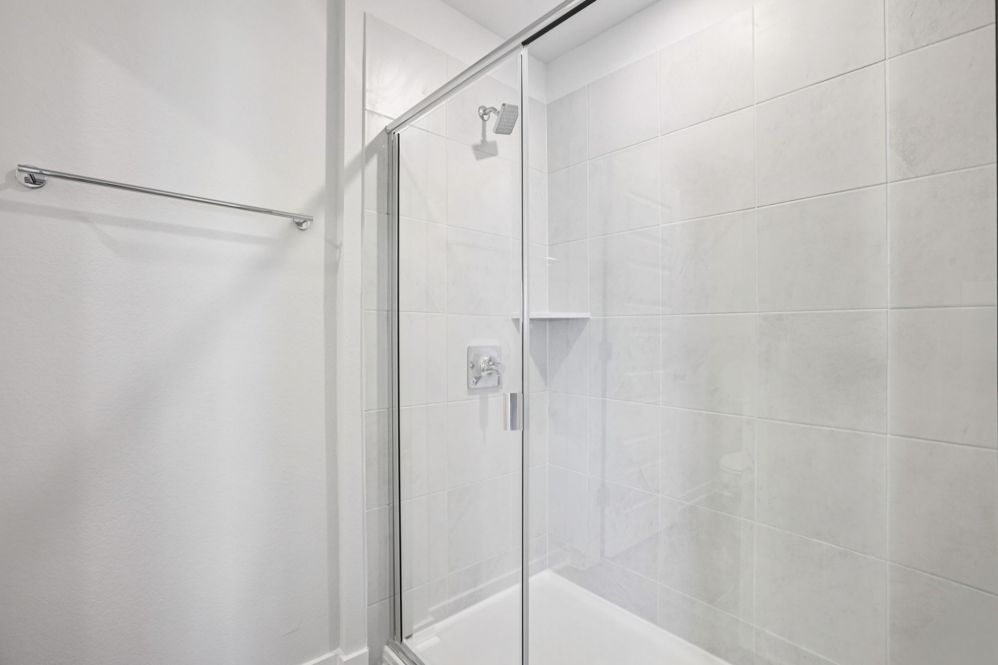 A shower with a glass door.