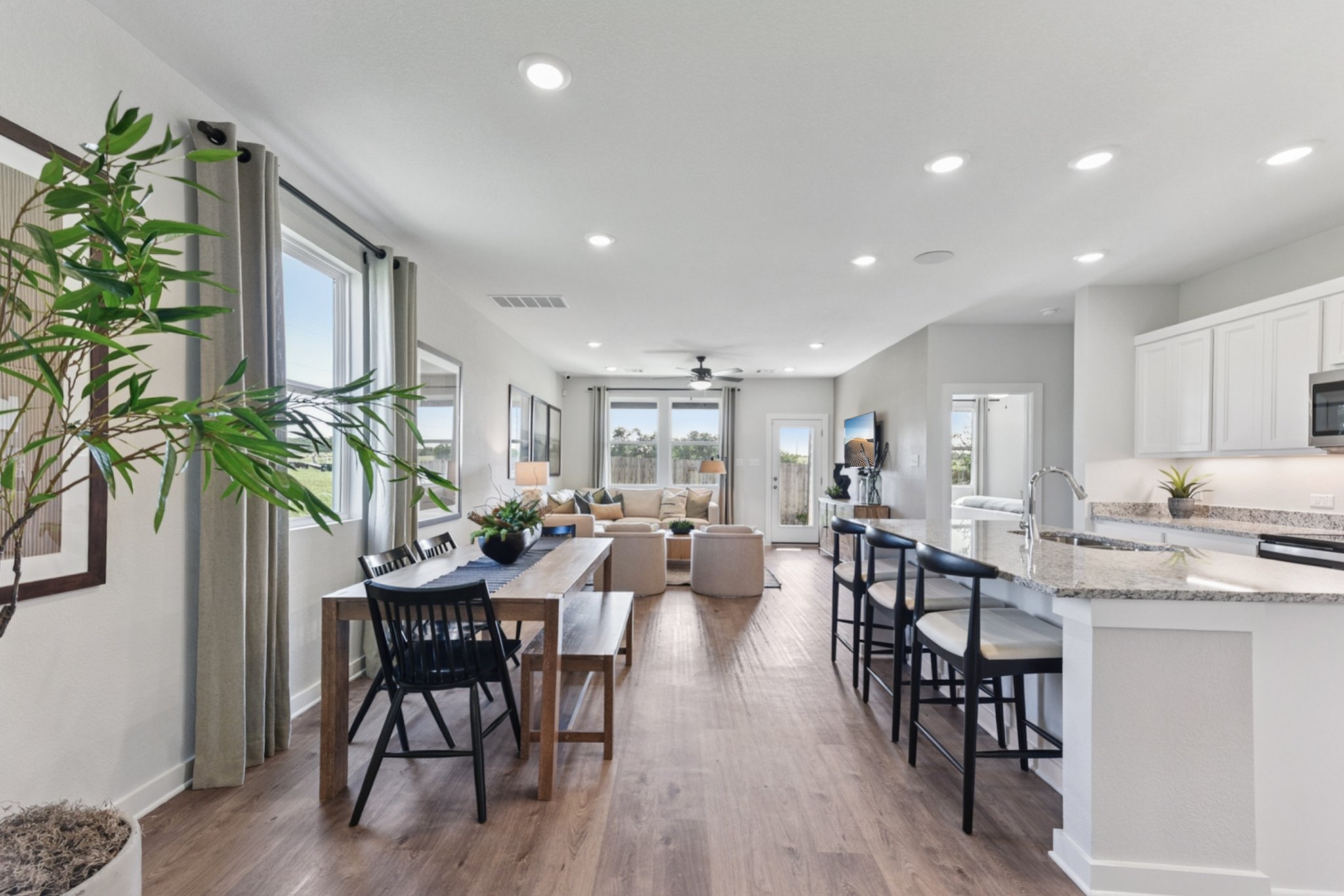 A kitchen with a dining table and chairs.