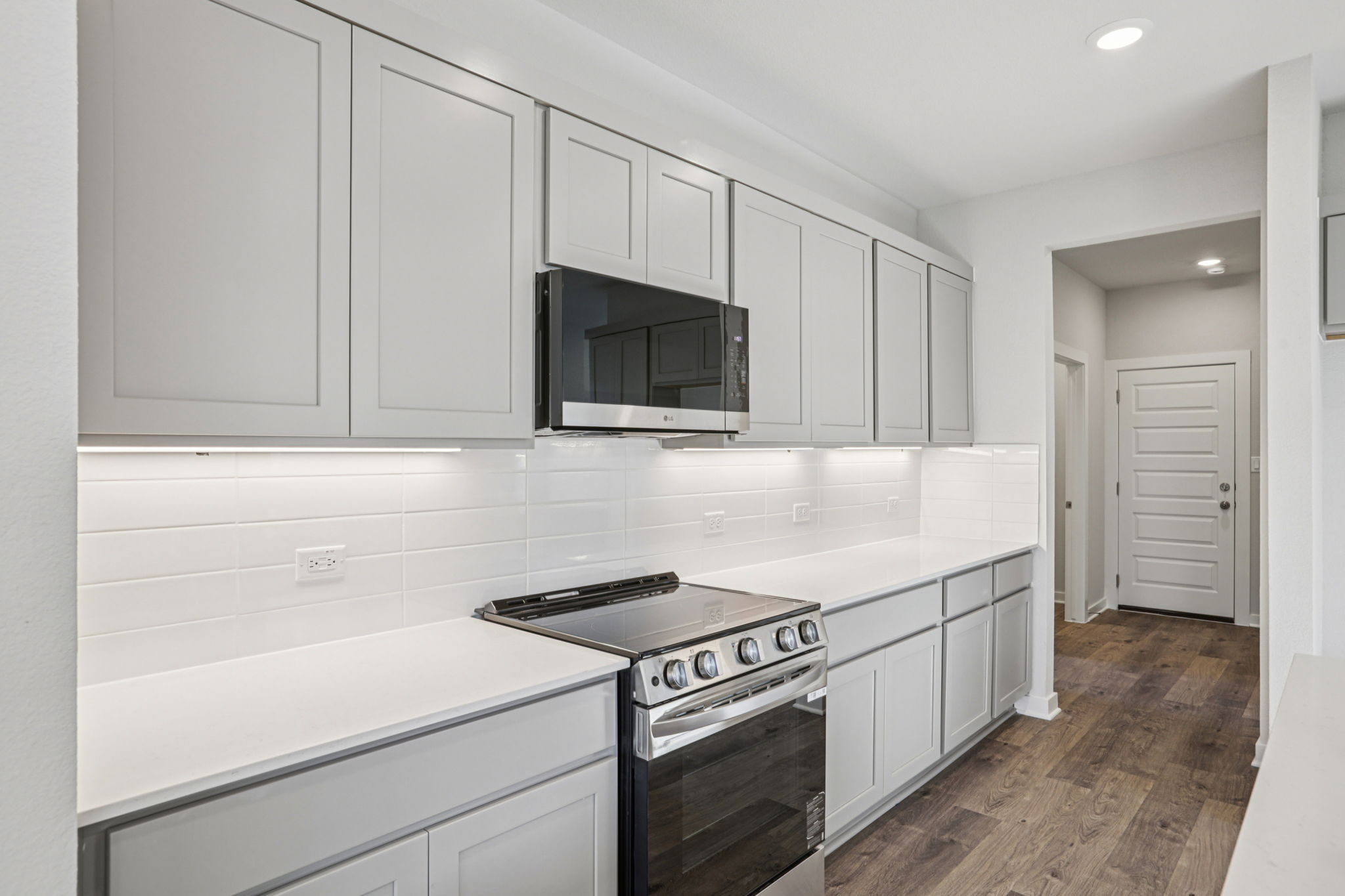 A kitchen with white cabinets.