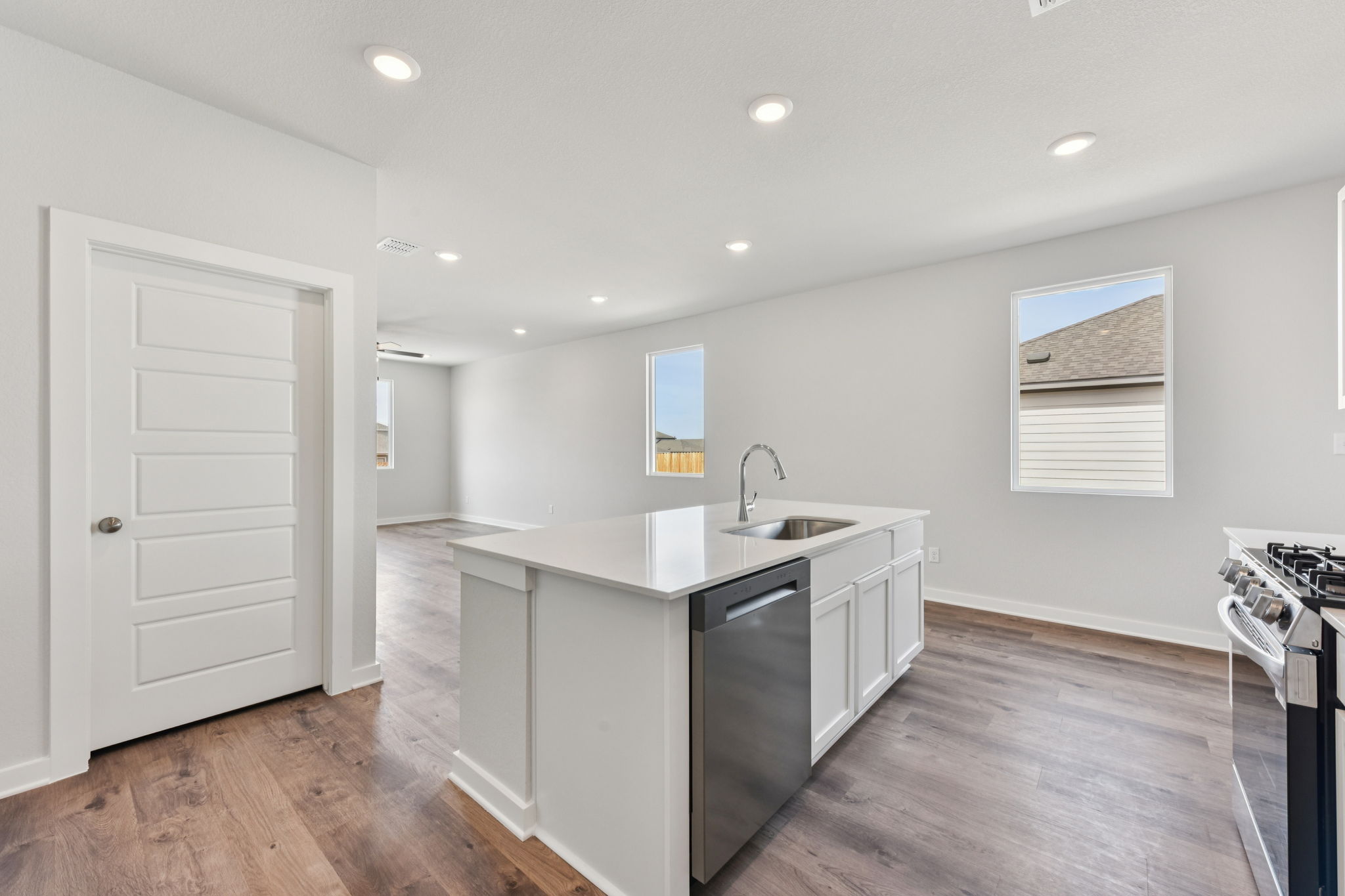 A kitchen with white cabinets.