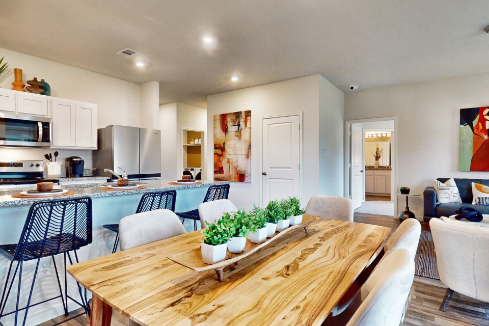 A kitchen with a dining table.
