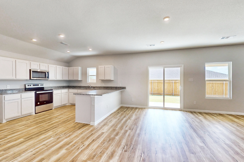 A large kitchen with white cabinets.