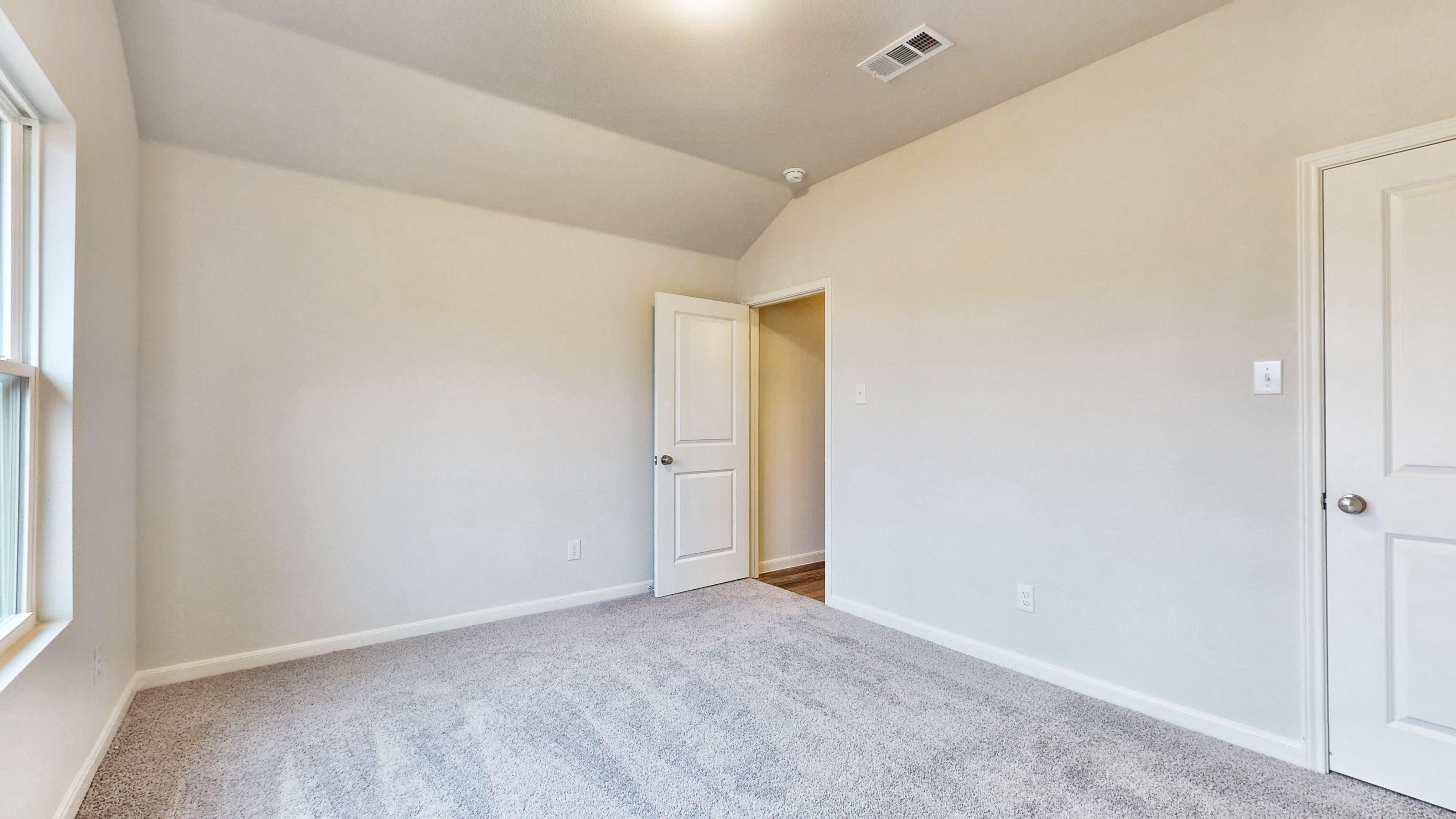 A hallway with white doors.