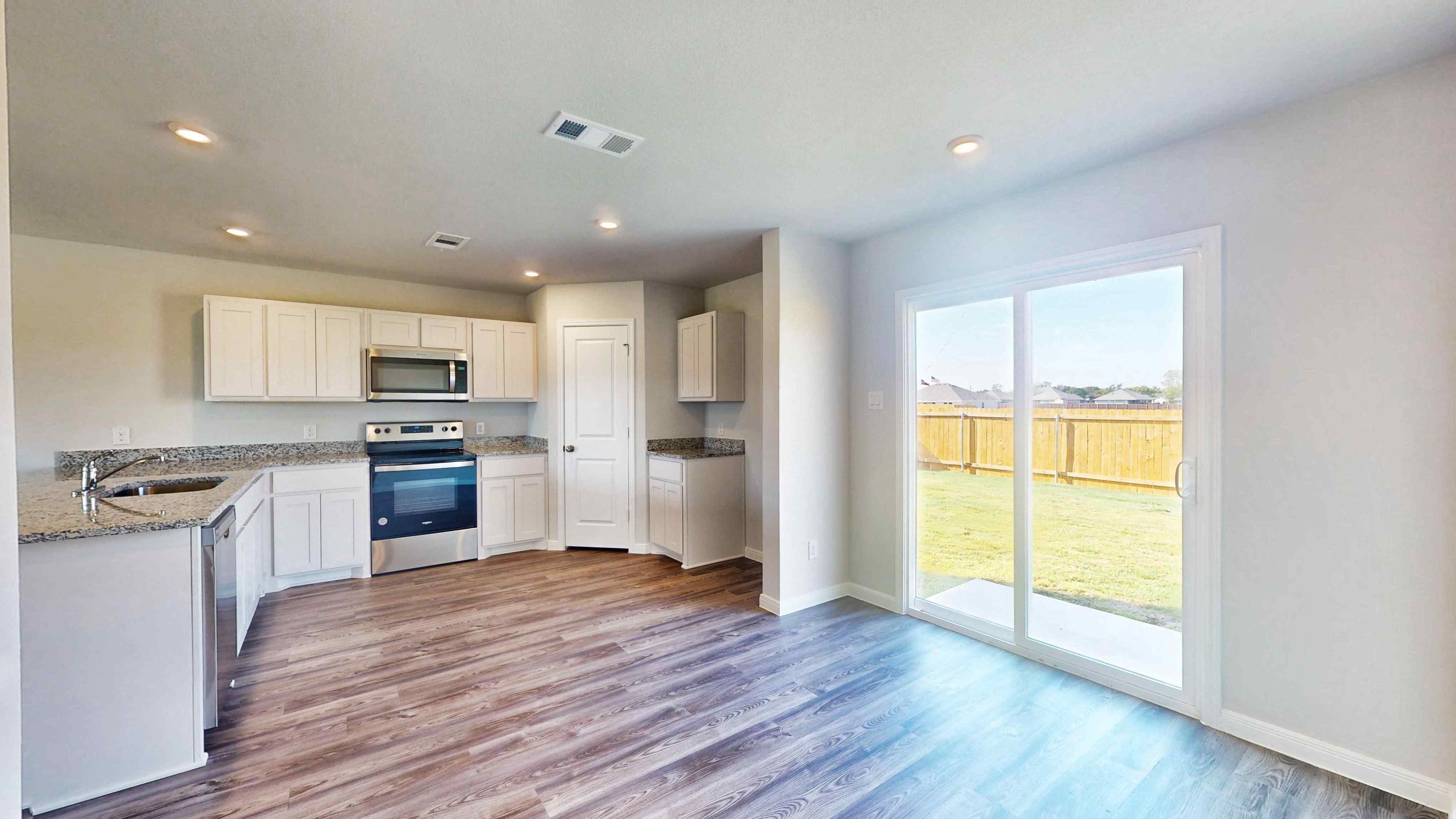 A kitchen with a large glass door.