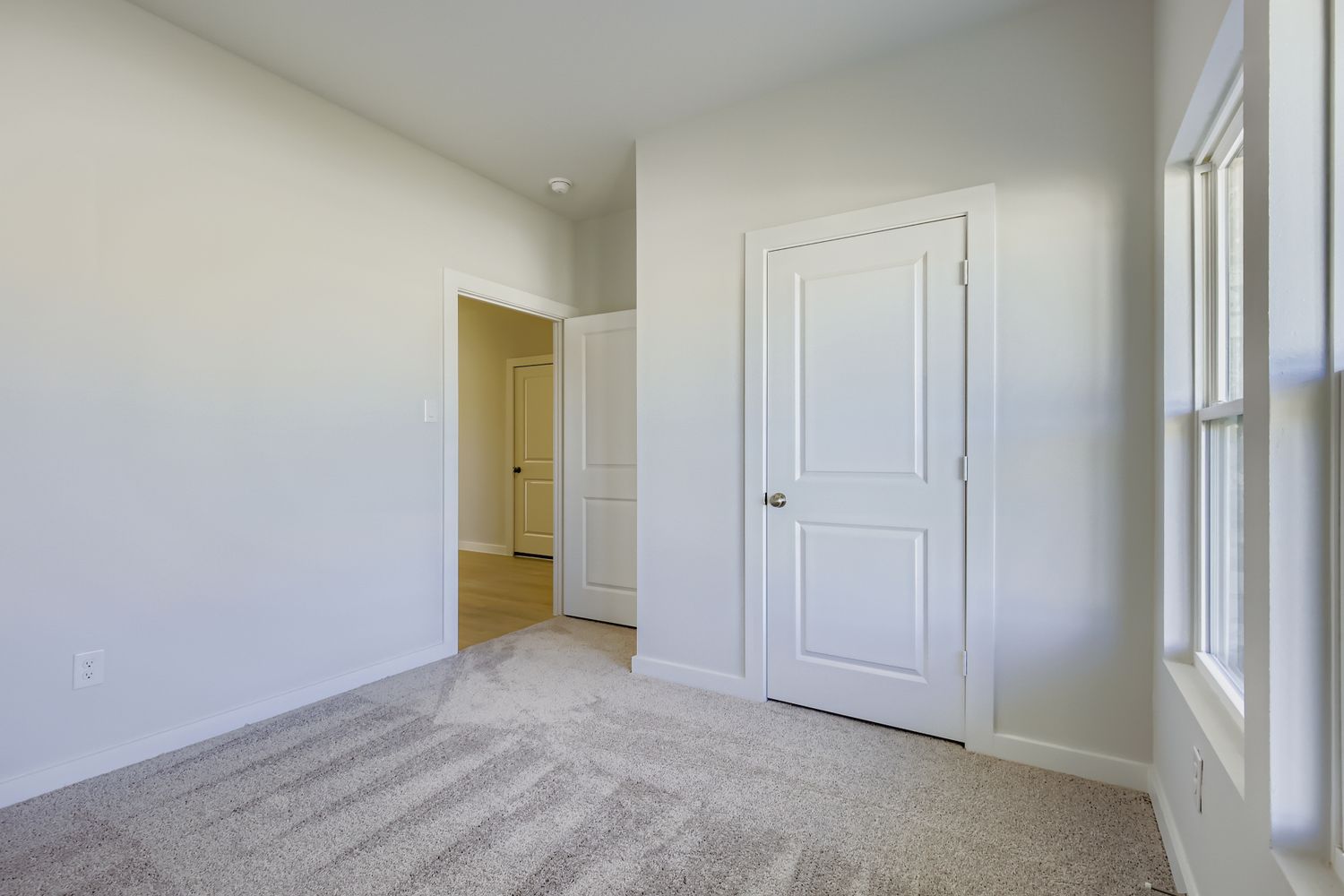 A hallway with white doors.