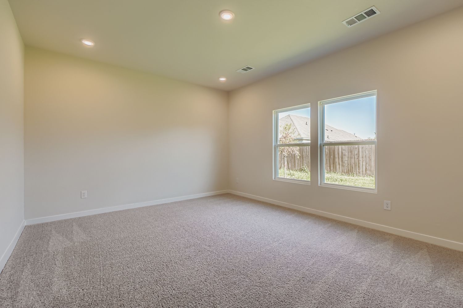 A room with a window and carpet.