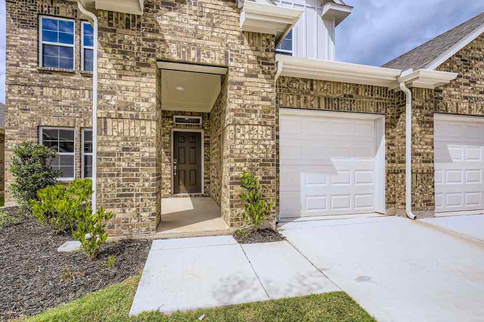A house with garages and a driveway.