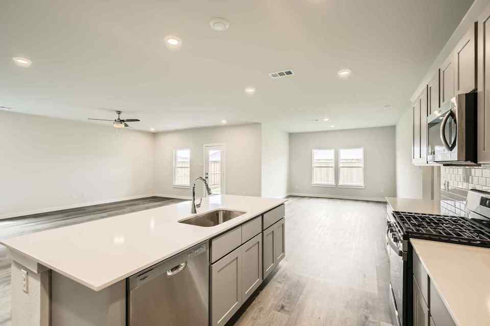 A kitchen with black cabinets.
