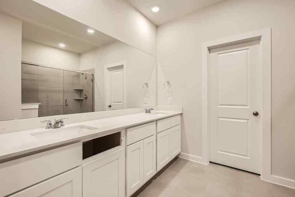 A bathroom with a large mirror.