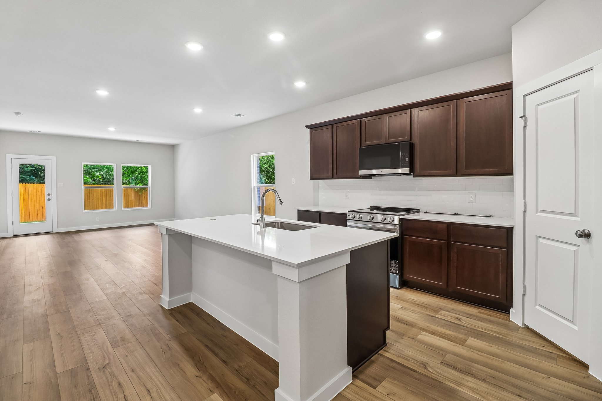 A kitchen with wooden cabinets.
