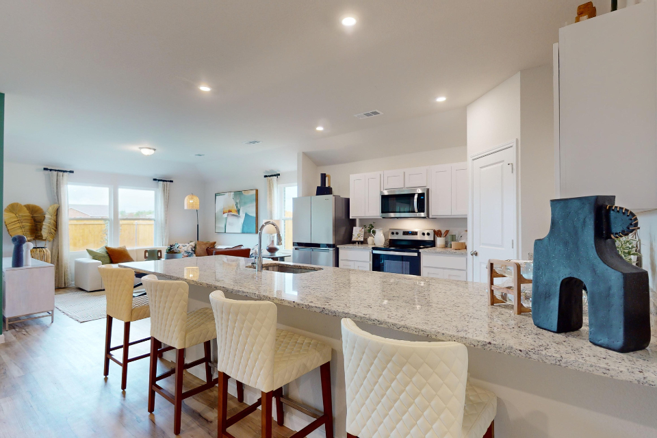 A kitchen with a marble island.
