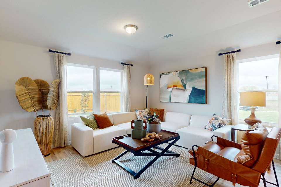 A living room with a white couch and a coffee table.