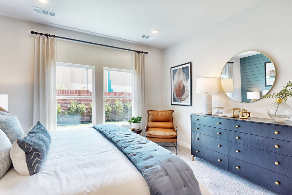 A bedroom with a large window.