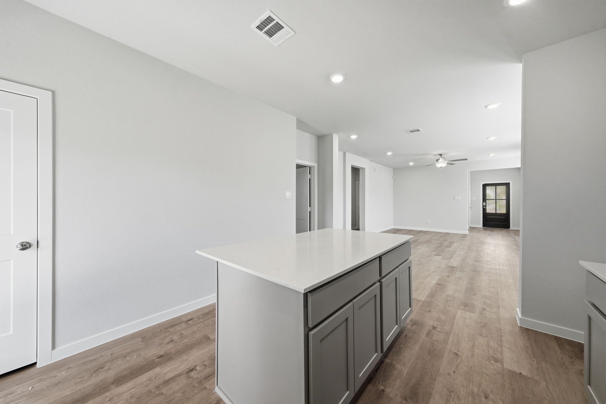 A large white room with a wood floor and white walls.