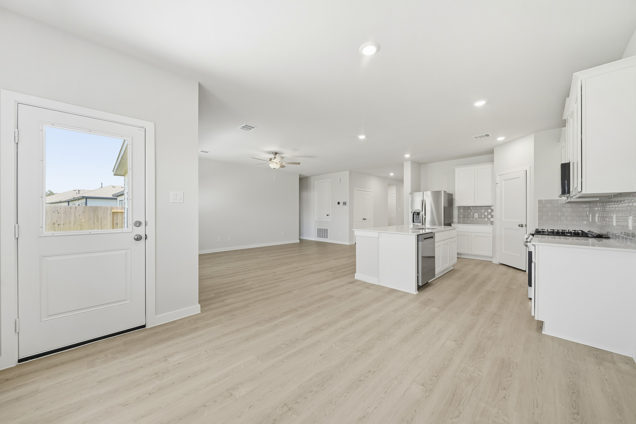 A large kitchen with white cabinets.