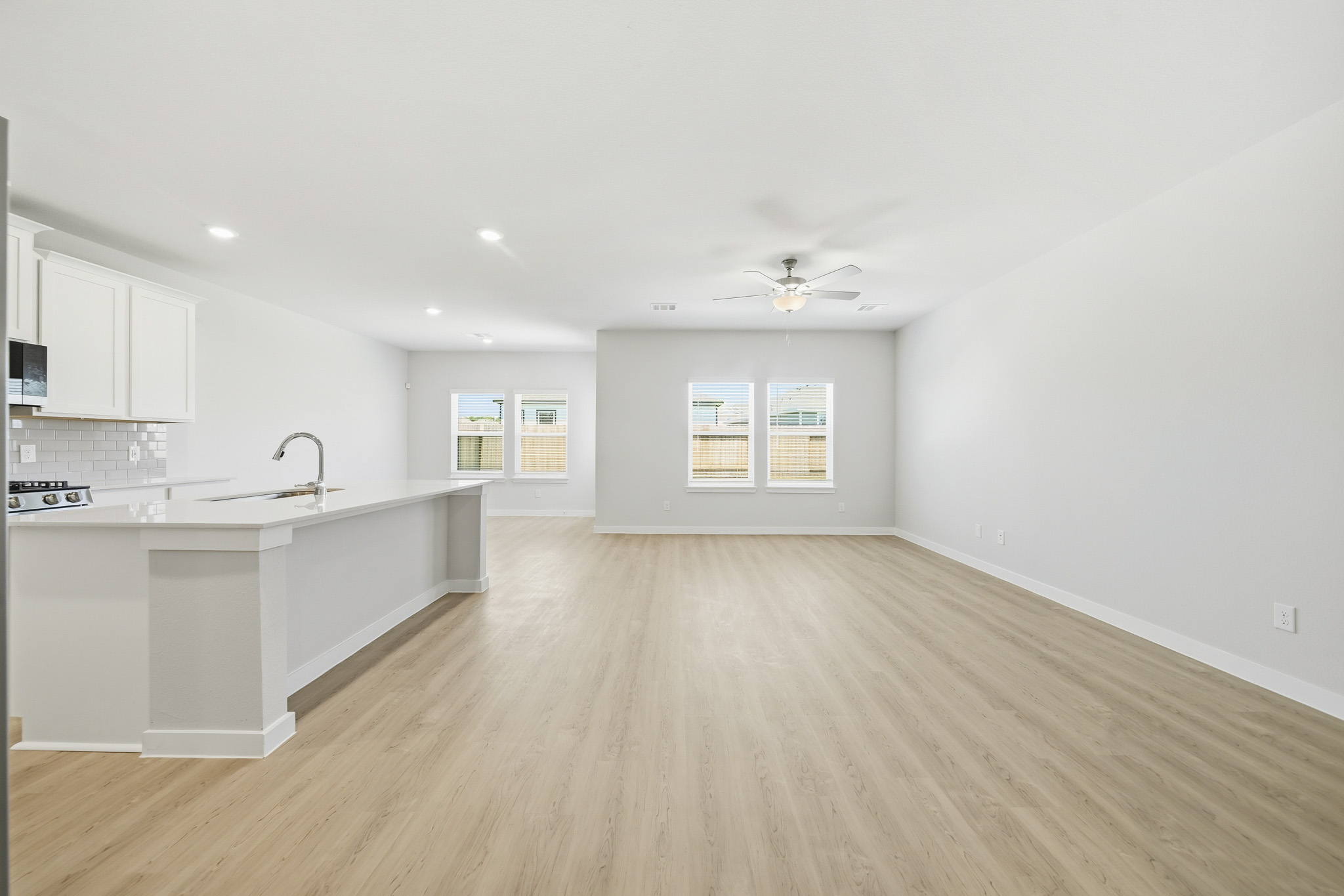 A kitchen with white cabinets.
