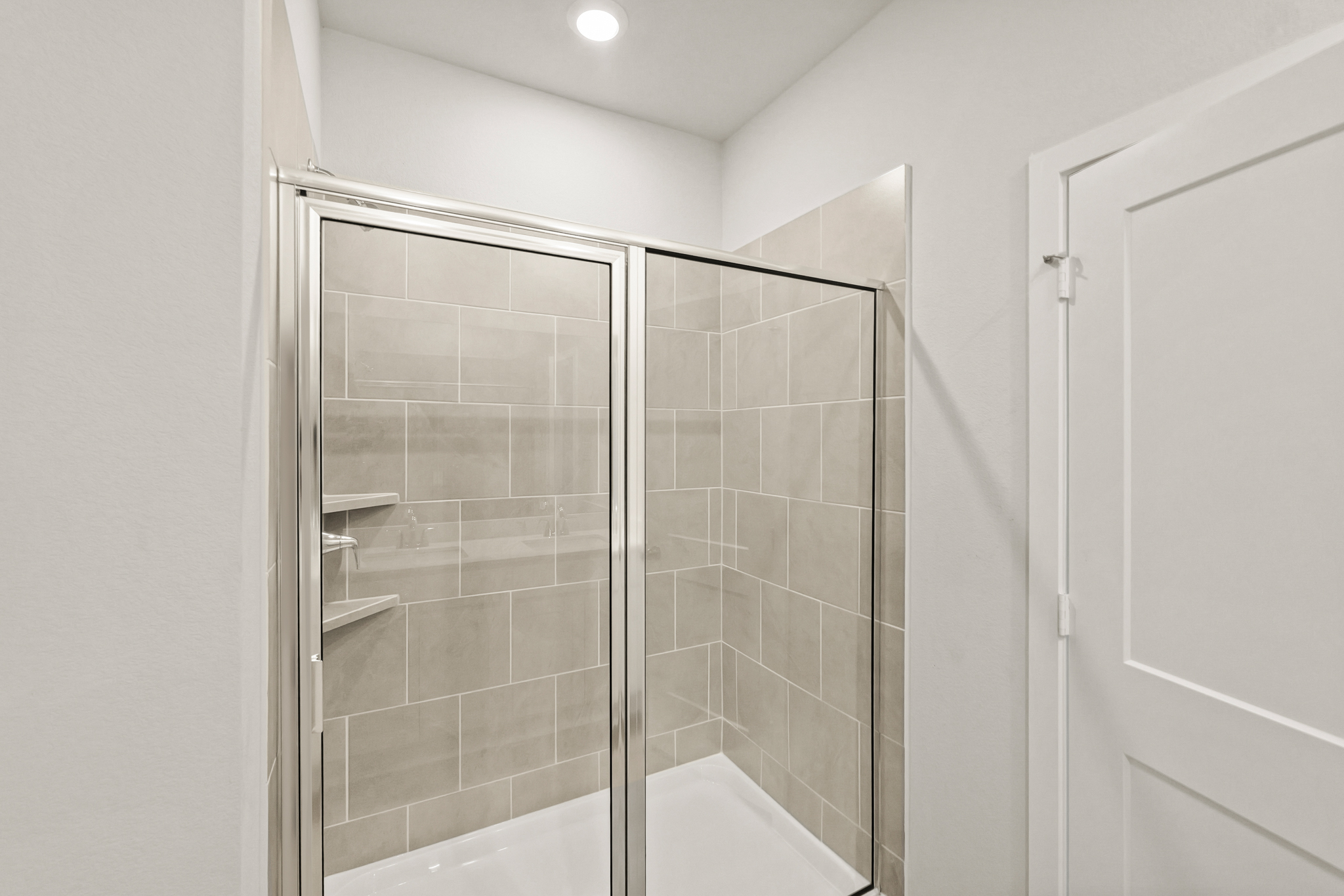 A shower with a glass door.