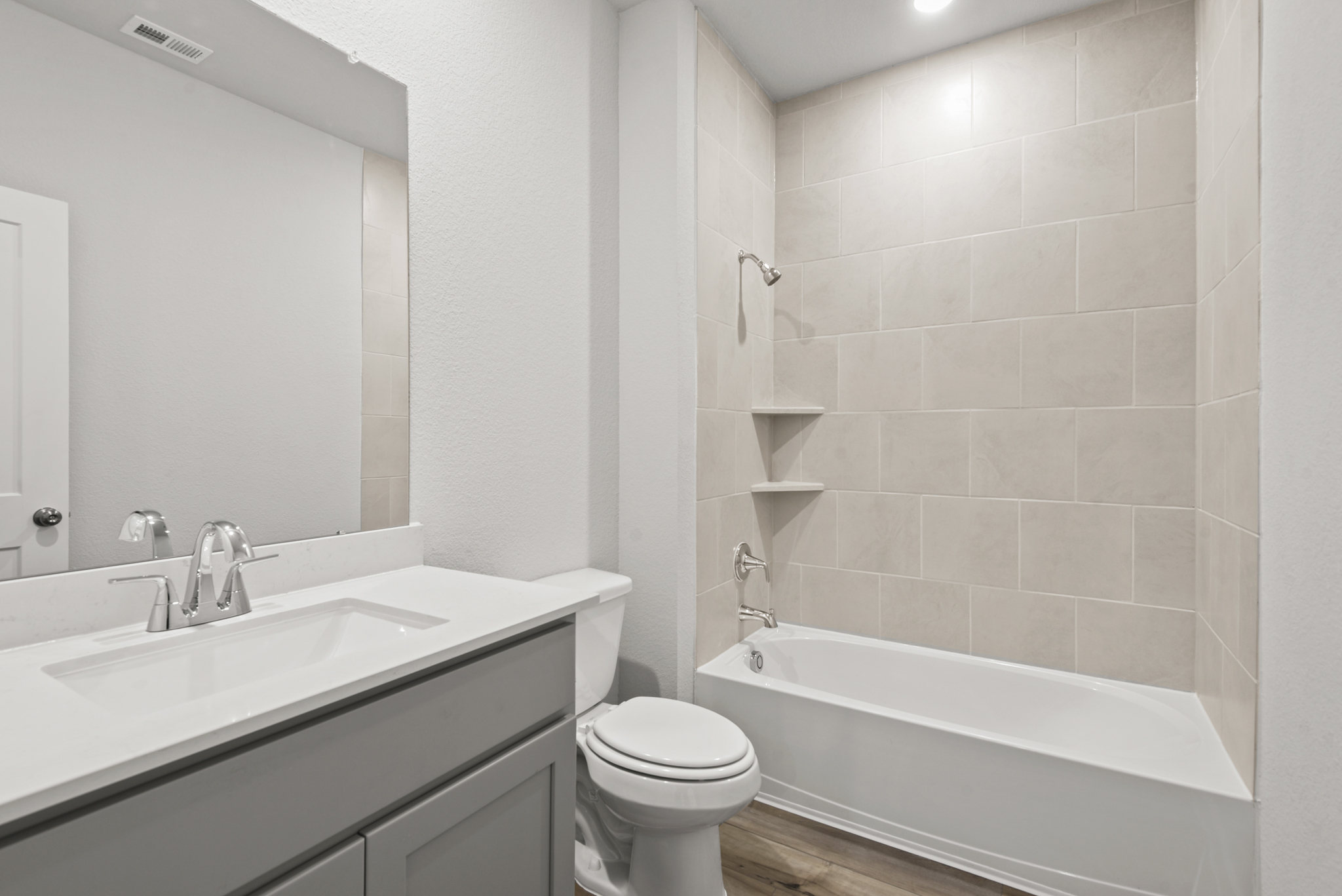 A bathroom with a tub sink and toilet.